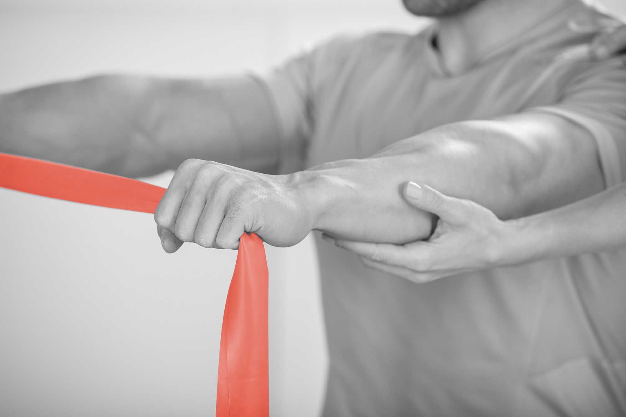 Close-up Of A Physiotherapist Giving Man A Training With Exercise Band